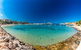 Port Adriano sandy beach Ikos Porto Petro